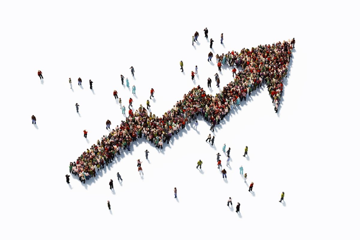 Human crowd forming an arrow shape on white background. Horizontal  composition with copy space. Clipping path is included. Finance concept.